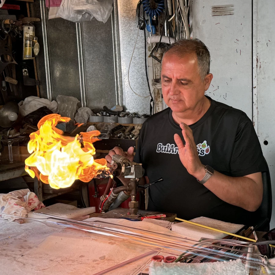 Producing handmade glass ornaments with glassblowing technique